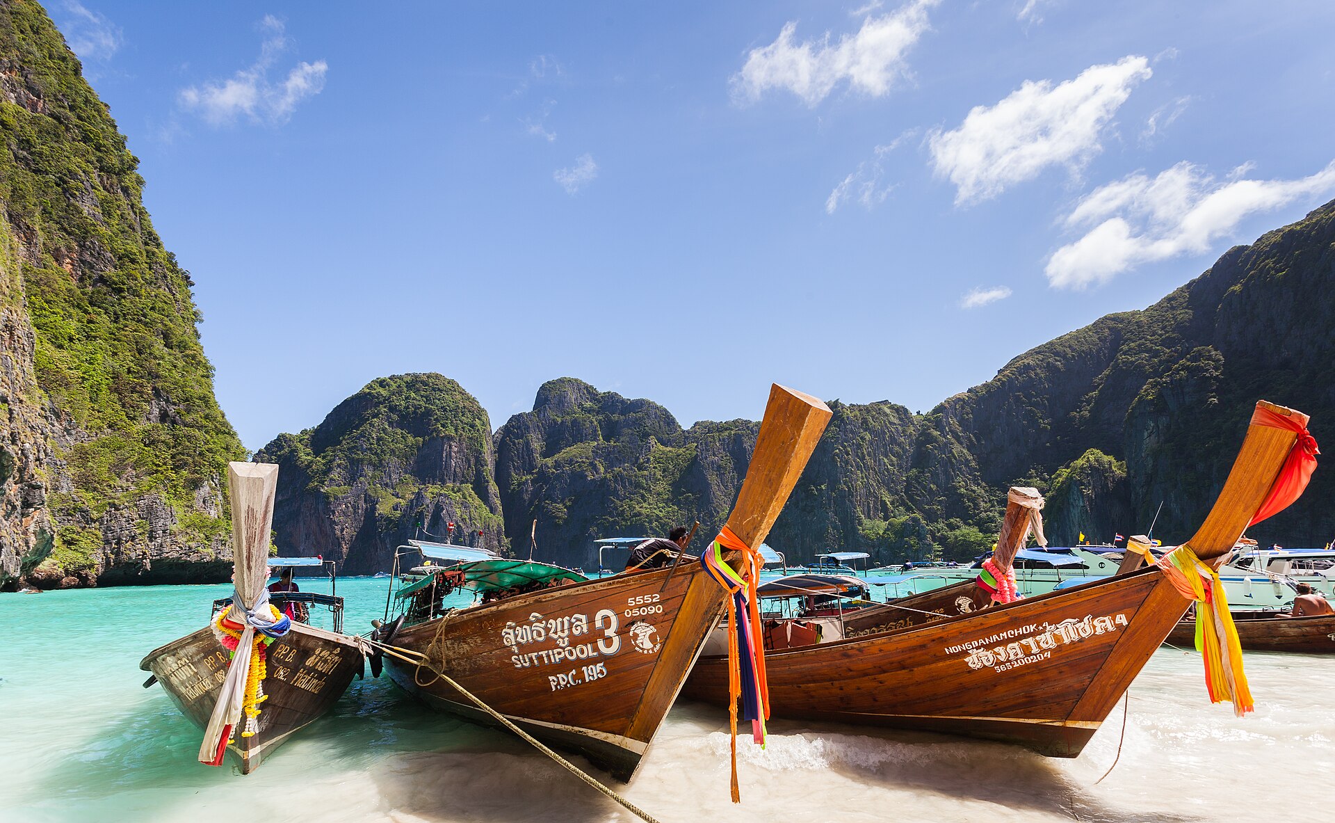Maya Bay on Ko Phi Phi Leh, longtail boats on the beach under the cliffs