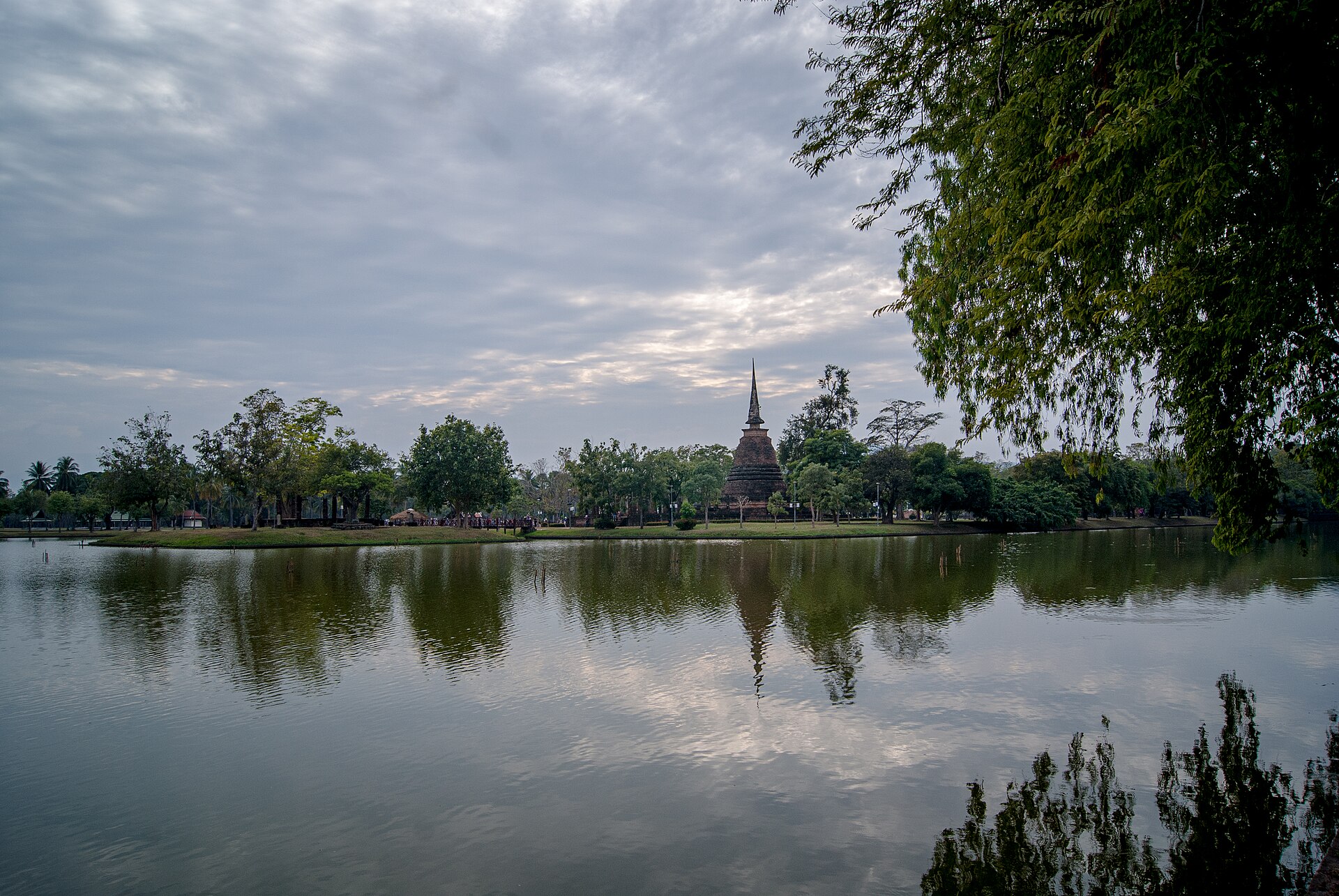 A chedi across the lake at dawn, Sukhothai Historical Park