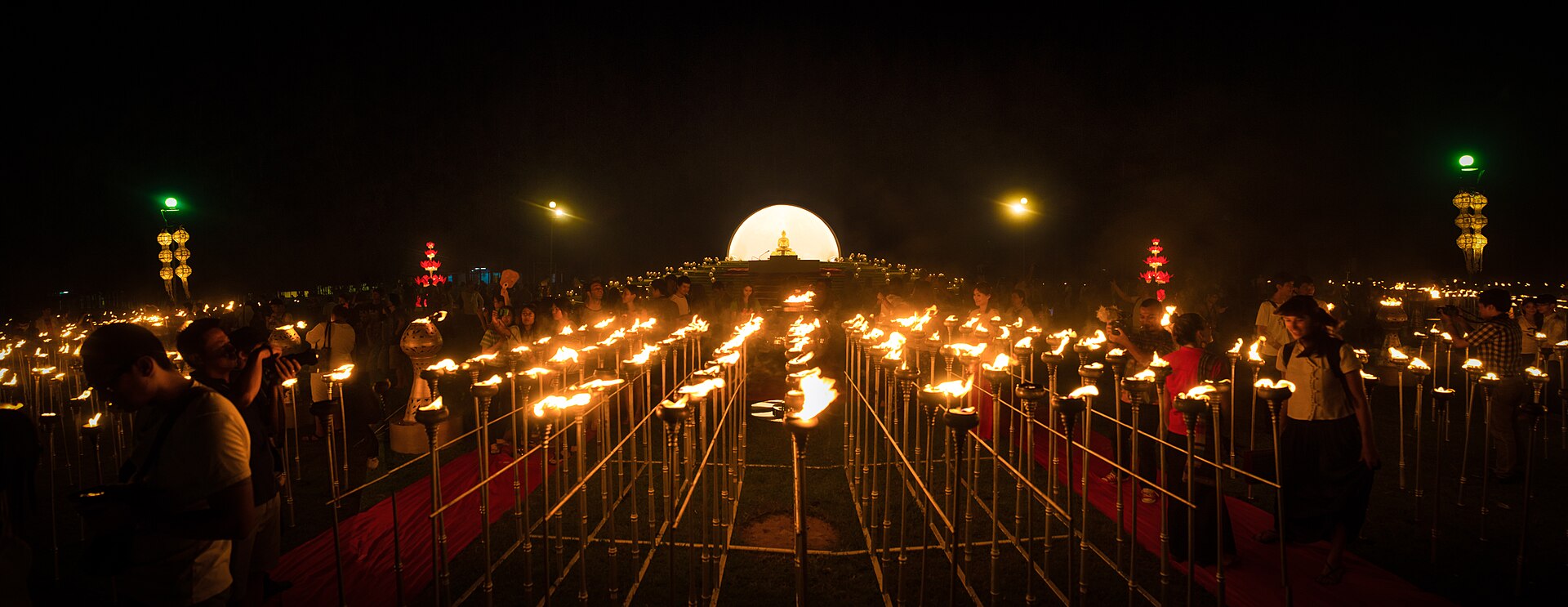 Candles and lanterns around a Buddha shrine at night during the Yi Peng festival, Chiang Mai